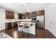 A well-appointed kitchen with dark wood cabinets, granite countertops, and stainless steel appliances at 5465 Mirror Lake Dr, Cumming, GA 30028