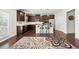 This spacious kitchen features dark wood cabinets, stainless steel appliances, and granite countertops at 5465 Mirror Lake Dr, Cumming, GA 30028
