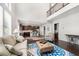 Bright living room featuring an open concept and a view into the modern kitchen and second story at 5465 Mirror Lake Dr, Cumming, GA 30028