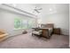 Spacious main bedroom featuring tray ceilings, a ceiling fan, and large windows at 5465 Mirror Lake Dr, Cumming, GA 30028