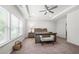 Spacious main bedroom featuring tray ceilings, a ceiling fan, and large windows at 5465 Mirror Lake Dr, Cumming, GA 30028