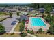 Community pool and amenity with lounge chairs, umbrellas, and ample parking in a neighborhood surrounded by trees at 5465 Mirror Lake Dr, Cumming, GA 30028
