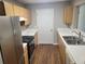 Kitchen featuring stainless steel appliances, wood cabinets, and white countertops at 1103 Waldrop Pl, Decatur, GA 30034