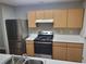 Kitchen featuring stainless steel appliances, wood cabinets, and white countertops at 1103 Waldrop Pl, Decatur, GA 30034