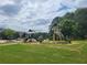 Community playground with green equipment on a grassy field at 1103 Waldrop Pl, Decatur, GA 30034
