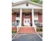 Inviting building entrance featuring a white door with wreath and brick stairs at 135 E Hill St # 12, Decatur, GA 30030