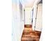 Clean hallway highlighting hardwood floors with a door leading to other rooms at 135 E Hill St # 12, Decatur, GA 30030