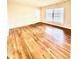 Bright living room featuring gleaming hardwood floors and natural light from large windows at 135 E Hill St # 12, Decatur, GA 30030