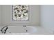 Close up of jacuzzi tub with decorative window at 1730 Point Pleasant Se, Smyrna, GA 30080