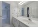 White bathroom with double sinks, and an opening leading to a bedroom at 1730 Point Pleasant Se, Smyrna, GA 30080