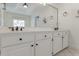 Bright bathroom features double sink vanity with modern fixtures and large mirror at 1730 Point Pleasant Se, Smyrna, GA 30080
