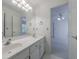 Bright bathroom featuring a double vanity with white cabinets and modern lighting at 1730 Point Pleasant Se, Smyrna, GA 30080