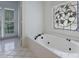 Jacuzzi tub with decorative window and doors leading to another bedroom at 1730 Point Pleasant Se, Smyrna, GA 30080