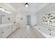 Bright bathroom with white cabinets and decorative window at 1730 Point Pleasant Se, Smyrna, GA 30080