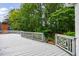 Spacious wooden deck surrounded by lush greenery and providing ample outdoor seating at 1730 Point Pleasant Se, Smyrna, GA 30080