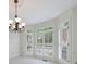 Bright dining room featuring a chandelier and a bay window with plantation shutters and transoms at 1730 Point Pleasant Se, Smyrna, GA 30080