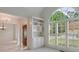 Bright dining room featuring large windows with shutters, built-in shelving, and a view into the home's foyer at 1730 Point Pleasant Se, Smyrna, GA 30080