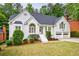 Charming two-story painted brick home featuring a well-manicured front yard, symmetrical design, and a two-car garage at 1730 Point Pleasant Se, Smyrna, GA 30080