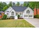 Charming two-story painted brick home featuring a well-manicured front yard, symmetrical design, and a two-car garage at 1730 Point Pleasant Se, Smyrna, GA 30080