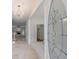 Elegant foyer featuring marble flooring, a decorative chandelier, and a view into a bright living room with a fireplace at 1730 Point Pleasant Se, Smyrna, GA 30080