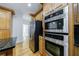 Kitchen features stainless steel appliances, granite counters, wood cabinets and hardwood floors at 1730 Point Pleasant Se, Smyrna, GA 30080