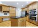 This kitchen has wood cabinets, stainless steel appliances and a large kitchen island at 1730 Point Pleasant Se, Smyrna, GA 30080