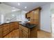 This kitchen has wood cabinets, granite countertops, and an island cooktop at 1730 Point Pleasant Se, Smyrna, GA 30080