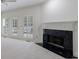 Living room with a fireplace and french doors on the side that lead to the deck at 1730 Point Pleasant Se, Smyrna, GA 30080