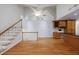 Open living room with wood floors, stairs, built in office, and island at 1730 Point Pleasant Se, Smyrna, GA 30080