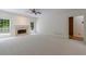 Bright living room features a fireplace, windows with backyard views and neutral carpet at 1730 Point Pleasant Se, Smyrna, GA 30080