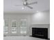 Living room with a fireplace and french doors on the side that lead to the deck at 1730 Point Pleasant Se, Smyrna, GA 30080