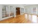 Open living room with hardwood floors, french doors, and view to an open kitchen space at 1730 Point Pleasant Se, Smyrna, GA 30080