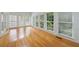 Bright sunroom with hardwood floors and windows with shades on the side of the room at 1730 Point Pleasant Se, Smyrna, GA 30080