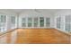 Bright sunroom with hardwood floors and large windows overlooking the backyard at 1730 Point Pleasant Se, Smyrna, GA 30080