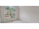 Bright room with carpet, a high ceiling, and large window with shutters, filling the space with natural light at 1730 Point Pleasant Se, Smyrna, GA 30080