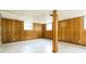 Finished basement with wood paneling, drop ceiling, and versatile open space at 2757 Shelley Ln, Ellenwood, GA 30294