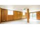 Large basement area with paneled walls and a sliding glass door to the outdoors at 2757 Shelley Ln, Ellenwood, GA 30294