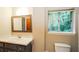 Bright bathroom with a vanity sink, toilet, and natural light at 2757 Shelley Ln, Ellenwood, GA 30294
