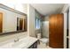 Well-lit bathroom with a vanity sink, toilet, and glass-enclosed shower at 2757 Shelley Ln, Ellenwood, GA 30294