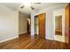 Neutral bedroom with hardwood floors, closet, and multiple doorways at 2757 Shelley Ln, Ellenwood, GA 30294