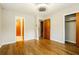 Bright bedroom with hardwood floors, ceiling fan and multiple doorways at 2757 Shelley Ln, Ellenwood, GA 30294