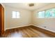 Comfortable bedroom with wood floors and natural light from two windows at 2757 Shelley Ln, Ellenwood, GA 30294