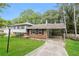 Charming split-level home featuring a carport, brick accents, and a well-manicured lawn at 2757 Shelley Ln, Ellenwood, GA 30294