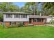 Charming split-level home with brick accents and a lush green lawn at 2757 Shelley Ln, Ellenwood, GA 30294