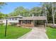 Charming split-level home with a well-maintained lawn and covered parking area at 2757 Shelley Ln, Ellenwood, GA 30294
