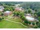 Aerial view showcases a community with a pool, garden, expansive green space, and multiple buildings at 5160 Pratt Sw St, Covington, GA 30014