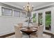 Bright dining room with a round table, chandelier, and French doors leading to the outdoor patio at 5160 Pratt Sw St, Covington, GA 30014