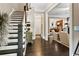 Elegant foyer with hardwood floors, staircase, and views into the living room and kitchen at 5160 Pratt Sw St, Covington, GA 30014