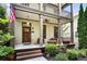 Inviting front porch with seating, landscaping, and a decorative door that enhances curb appeal at 5160 Pratt Sw St, Covington, GA 30014
