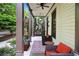 Inviting front porch with comfortable seating, a ceiling fan, and views of lush landscaping at 5160 Pratt Sw St, Covington, GA 30014